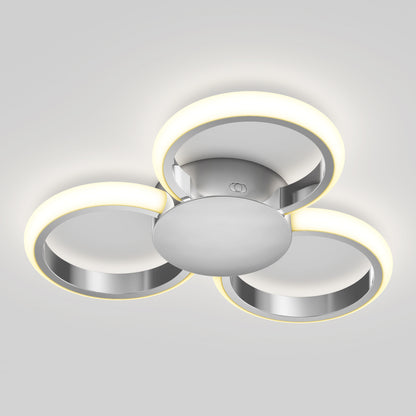 The Artika Nyala 15 in. LED flush mount light features three circular rings arranged triangularly on a central metallic base, providing a soft white glow and modern style to any space.