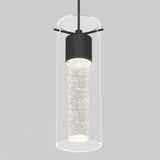 A modern pendant light with a cylindrical glass shade and a black metal fixture, featuring a sparkling, bubble-filled inner tube illuminated from within. The background is plain light gray.
