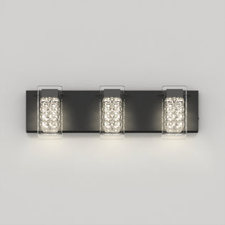 The Artika Crystal Cube LED bathroom vanity light 5 CCT is a modern black wall sconce featuring three textured rectangular crystal glass shades mounted on a flat black base against a light gray wall.