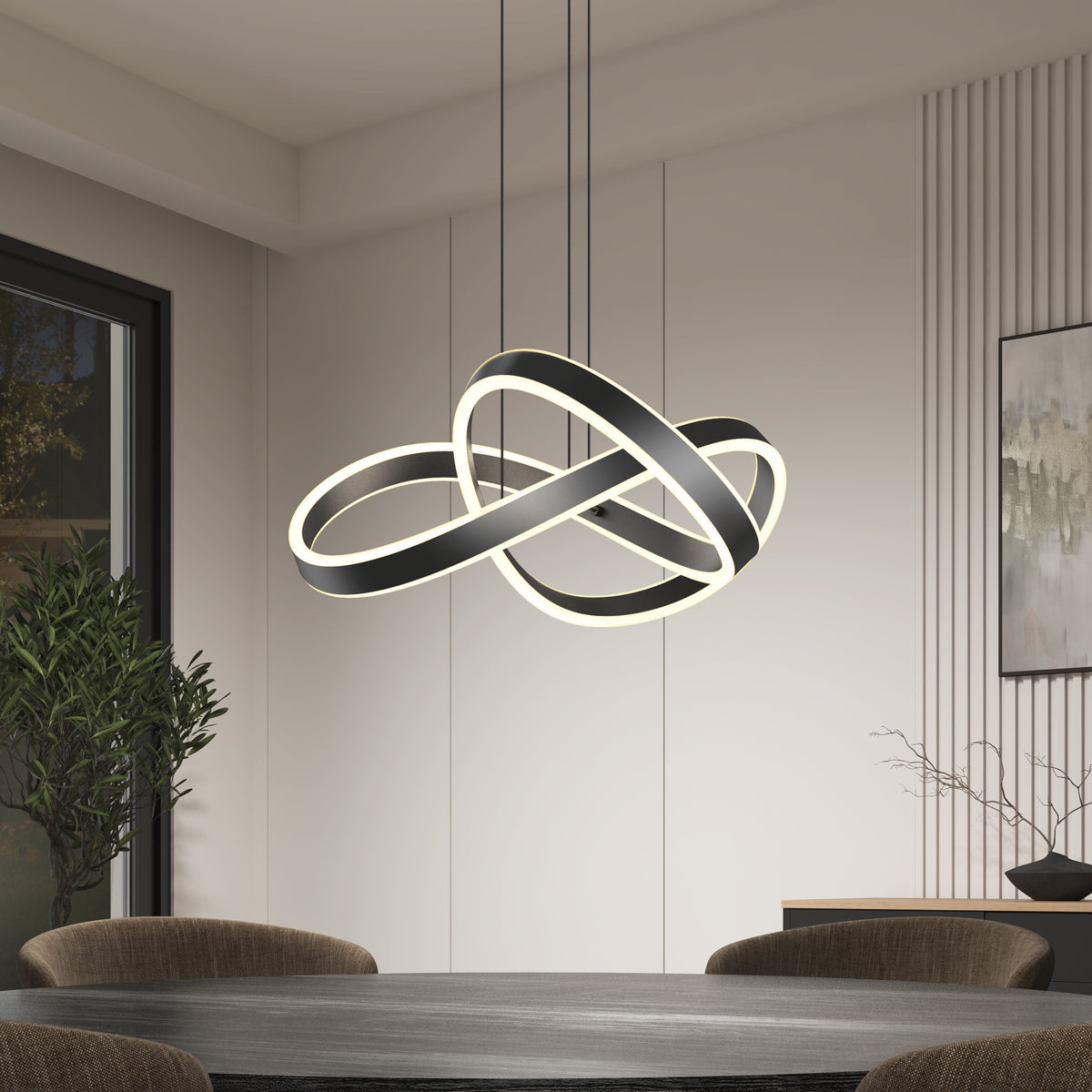 A modern dining room features a round table with dark chairs, illuminated by the Artika Bolero LED pendant light 5 CCT, showcasing interlocking rings above. A potted plant and minimalist decor complete the background.