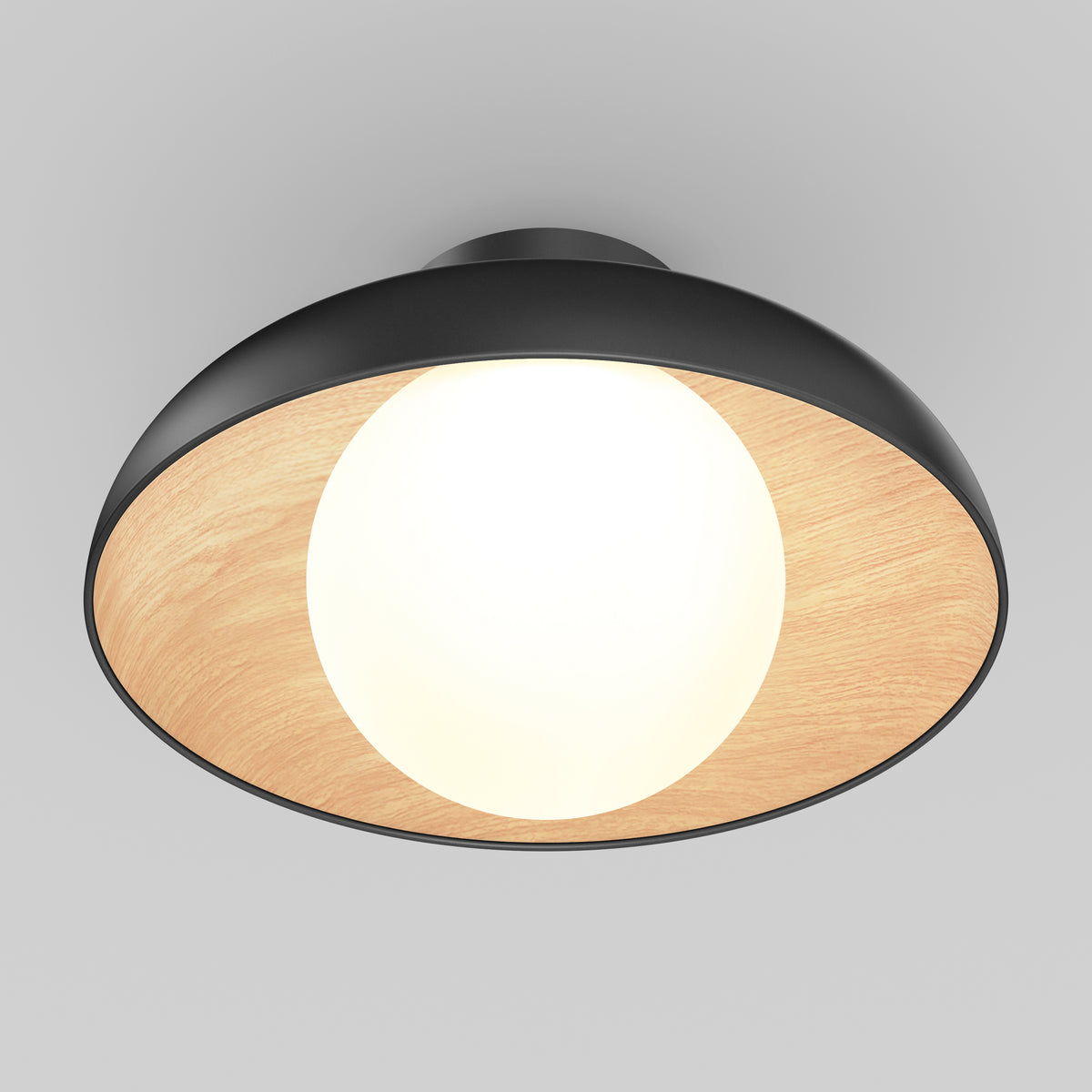 A modern ceiling light fixture with a black outer rim and a light wood interior, featuring a round, glowing bulb at the center against a neutral gray background.