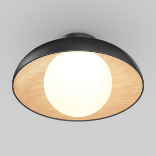 The Artika Boden LED flush mount light 5 CCT features a modern design with a black outer rim, wooden inner lining, and glowing white bulb at the center, displayed against a plain gray background.