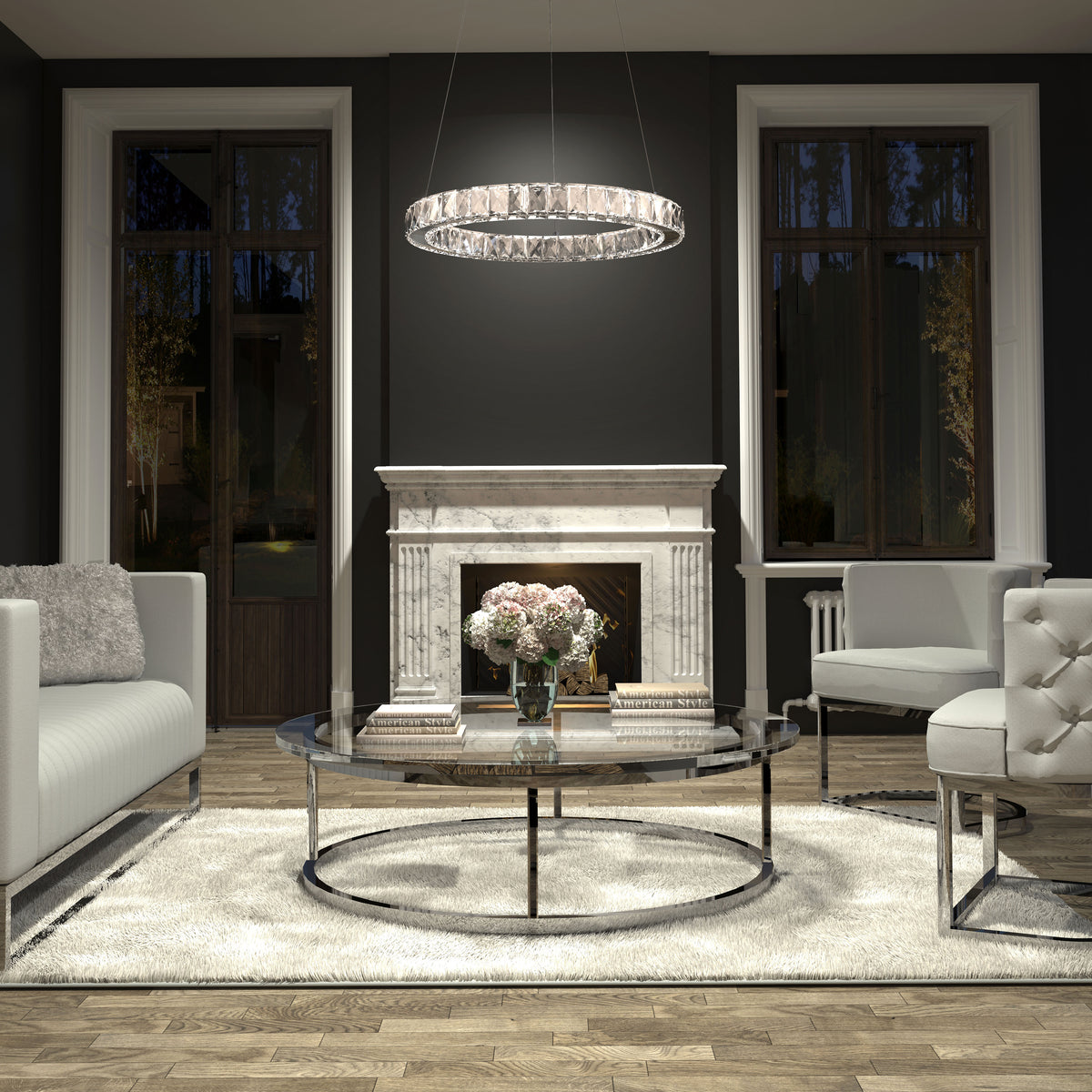 A modern living room with a marble fireplace, round glass coffee table, white sofas, and a circular chandelier. A vase of pink flowers and books sit on the table, with large windows on either side of the fireplace.