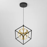 A modern pendant light featuring a black metal cube frame with a gold geometric sphere suspended inside, hanging from the ceiling by a black cord against a plain white background.