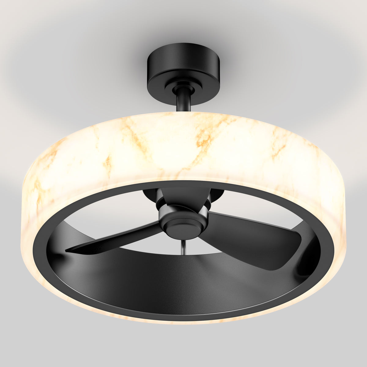 A modern ceiling fan with three black blades, encased in a circular, marble-patterned light fixture, mounted on a white ceiling.