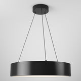 A modern, circular black pendant light hangs from the ceiling by four thin black cables, emitting a soft white glow from its underside against a plain white background.
