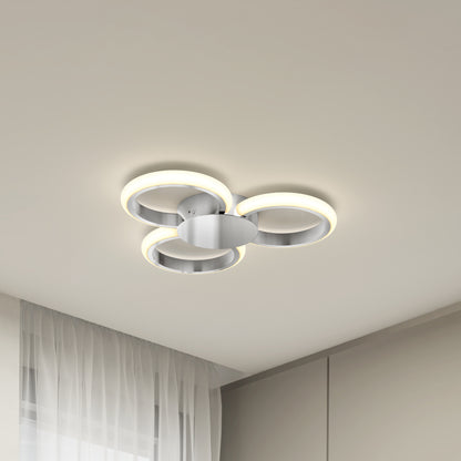The Artika Nyala 15 in. LED flush mount light 5CCT features three illuminated rings and a metallic base, shown installed on a white ceiling in a minimalist room with sheer curtains and neutral walls.