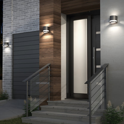Sleek front door with wood, brick, metal railings, steps, and Artika Valor Round LED Wall Lights brightening the entryway.