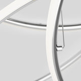 Close-up of intersecting white and chrome metal tubes with smooth curves against a light gray background, showing a sleek, modern design.