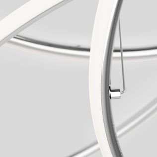 Close-up of the Swirl Butterfly LED contemporary pendant light by Artika, featuring intersecting smooth curved metal rods with a white and silver finish. The sleek, modern design stands out against a light grey background.