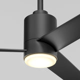 Close-up view of a modern black ceiling fan with three blades and an integrated round LED light, shown against a plain light gray background.