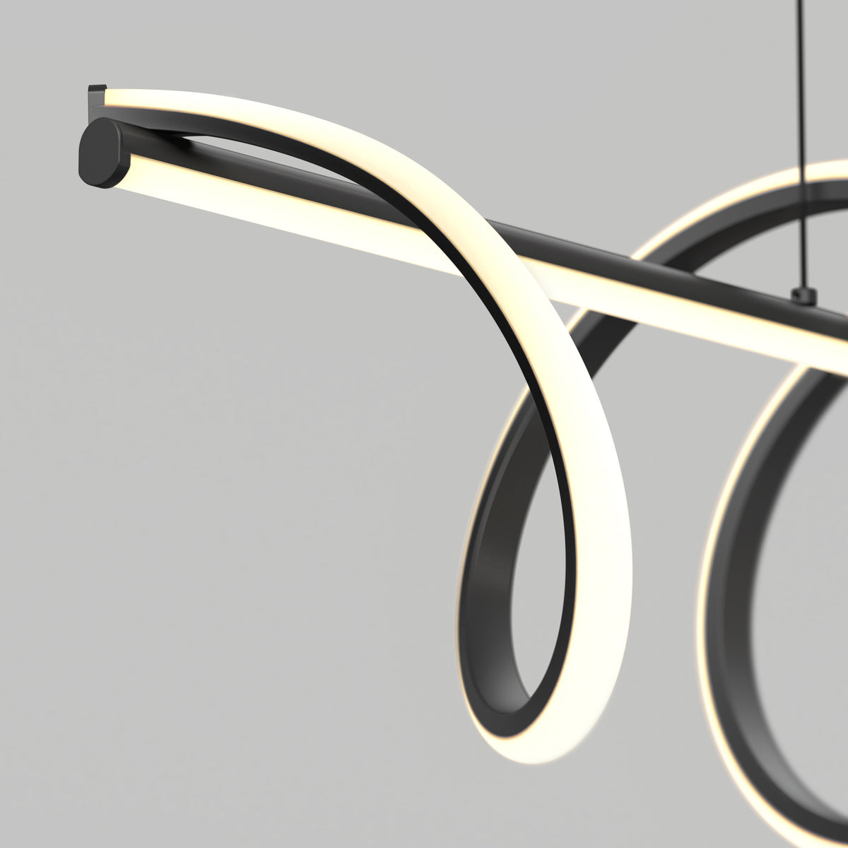 A modern, minimalist LED pendant light with black and white looping curves, suspended against a plain gray background. The design features flowing, illuminated bands creating an abstract, elegant shape.