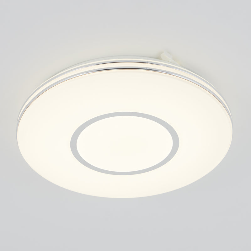 The Artika Horizon 13 in. LED flush mount light features a dimmable glowing white center and silver ring, mounting elegantly on ceilings.