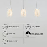 Three modern pendant lights hang from the ceiling above icons and text listing features: LED integrated, 1200 lumens, dimmable, 50,000 hours lifespan, and easy installation with a safety hook included.