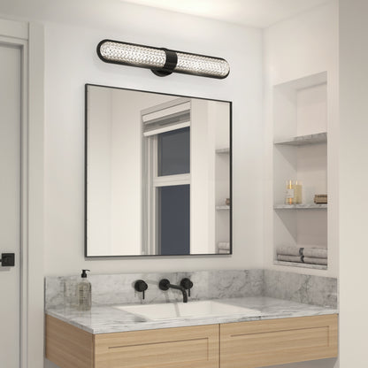 Modern bathroom with a marble countertop, rectangular mirror, wall-mounted black faucet, shelves for towels and toiletries, and the Artika Carat LED contemporary bathroom vanity light 3 CCT above the mirror.