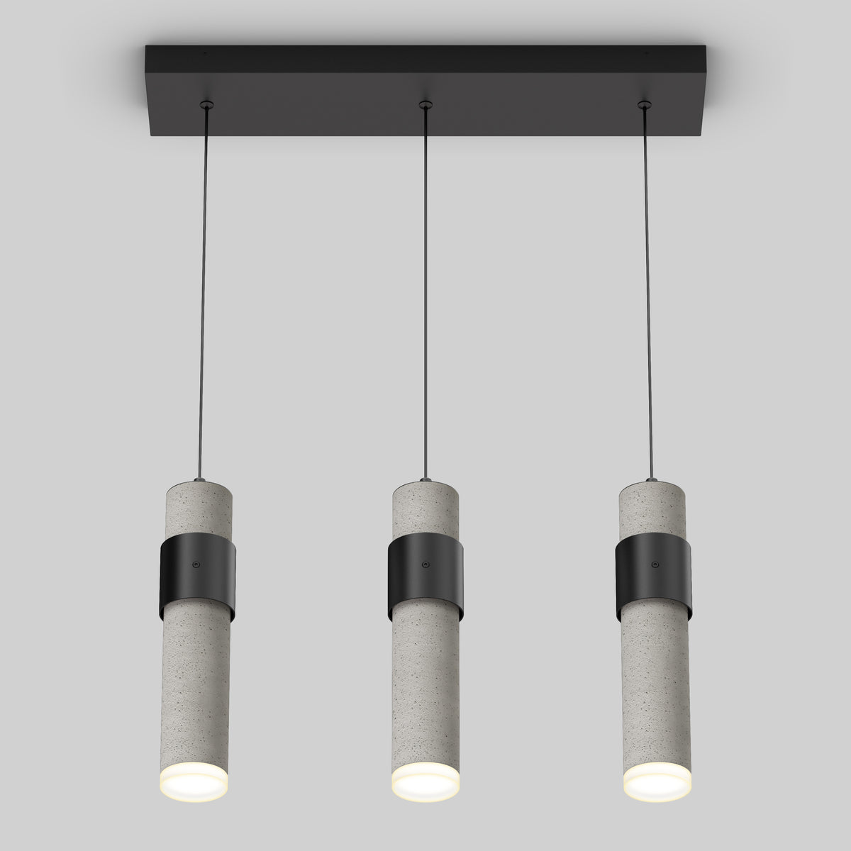The Artika Barden 3-light LED pendant light features three cylindrical concrete pendants suspended from a rectangular black base, each casting a soft white glow.