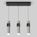 A modern ceiling light fixture with three cylindrical pendant lights hanging from a rectangular black base, each light has a concrete-like texture and emits a soft white glow.