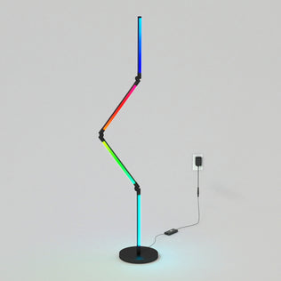 The Artika Fitch smart foldable RGB LED gaming floor lamp features a zigzag, multicolored light on a round black base with a visible black cord, set against a plain light gray background.