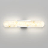 A modern, wall-mounted light fixture with a long, rounded, frosted glass shade featuring marble-like patterns, emitting a soft, warm glow against a smooth gray wall.
