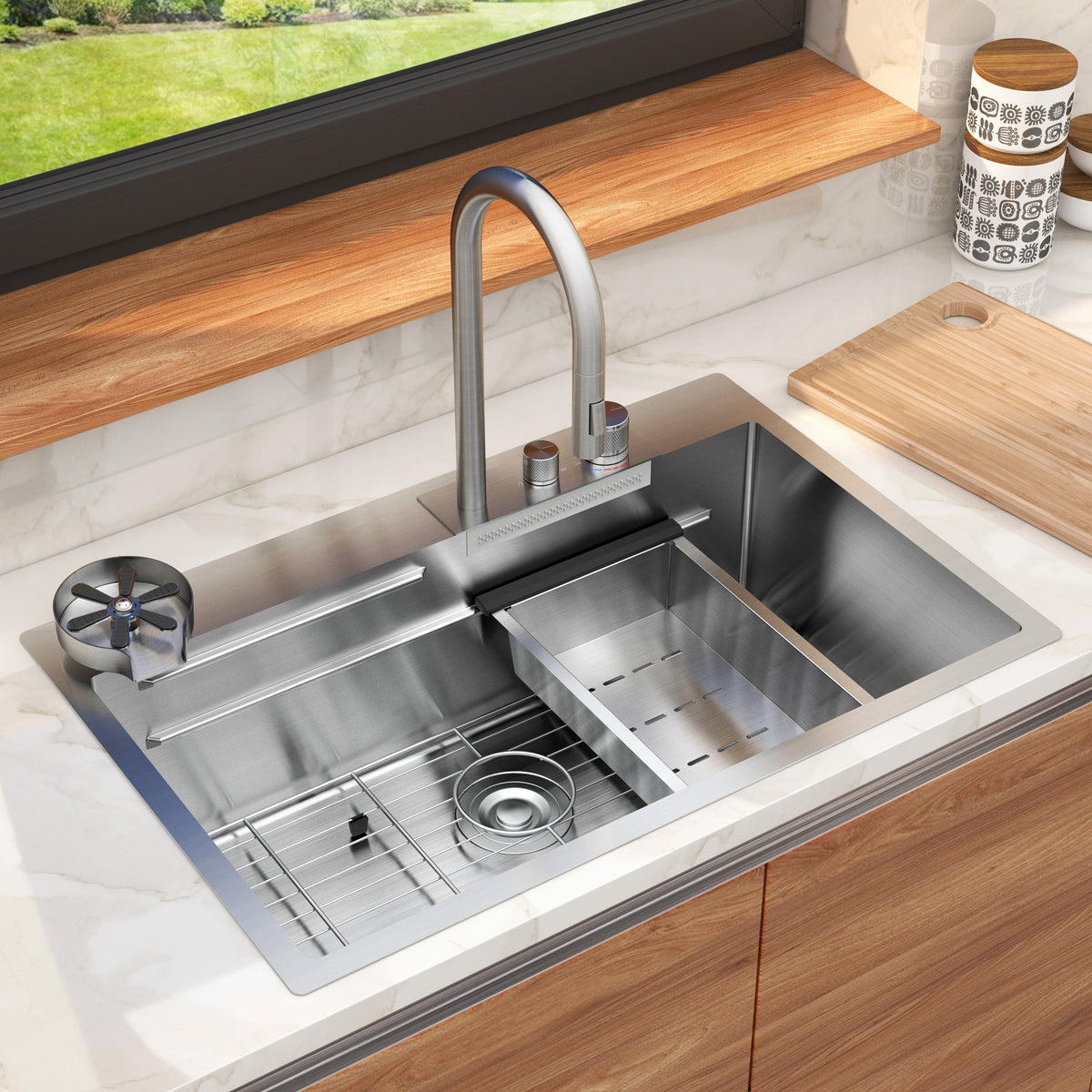 A modern stainless steel kitchen sink with a sleek faucet, divided basin, wire rack, and accessories, set in a wooden countertop beneath a window with a garden view. Cutting boards and containers are nearby.