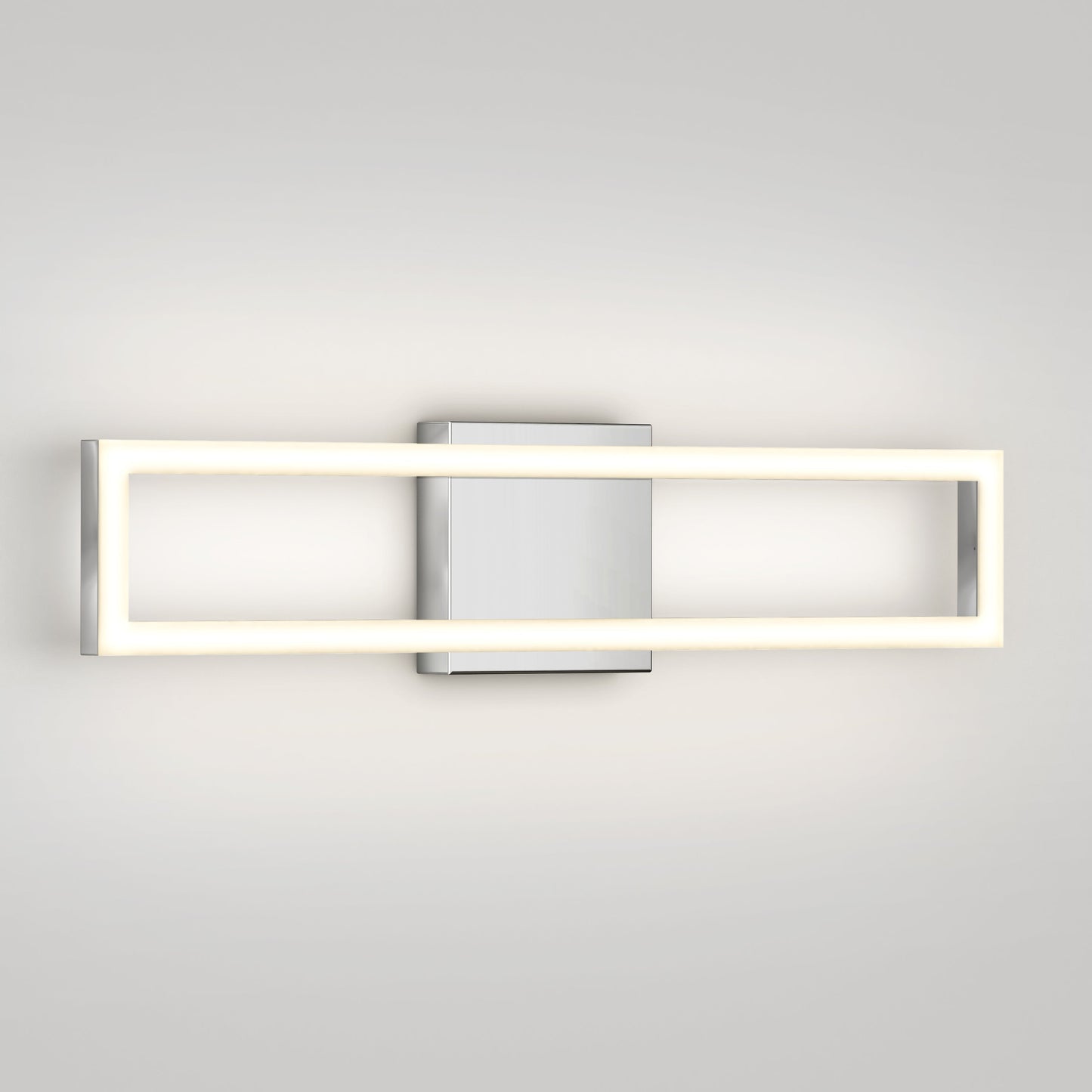 The Artika-CAN-dev Dover modern LED bathroom vanity light 5 CCT features a rectangular LED frame and central silver mounting plate, casting a soft, even glow on a light-colored wall.