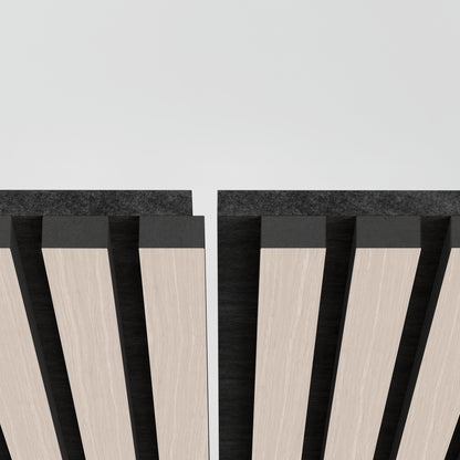 Close-up of two Artika Sonolok 15.5 ft sound-absorbing wall panels (from the 4-pack kit) with vertical, alternating light wood and black stripes against a white background, showing a narrow gap at the top center.