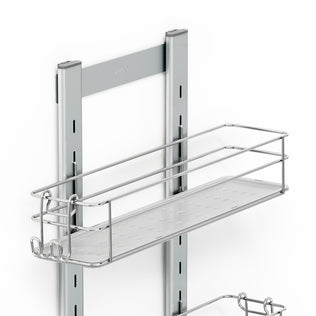 The Artika Camden Shower Caddy is a metal wall-mounted rack with a rectangular wire basket and hooks on two vertical rails, ideal for organizing items in kitchens or bathrooms. The product is shown against a white background.