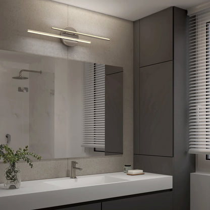 Modern bathroom featuring a large mirror, sleek countertop sink, minimalist faucet, gray cabinets, a small plant, and a window with white blinds. Above the mirror is the Artika Cisco modern LED bathroom vanity light 5 CCT for premium lighting.