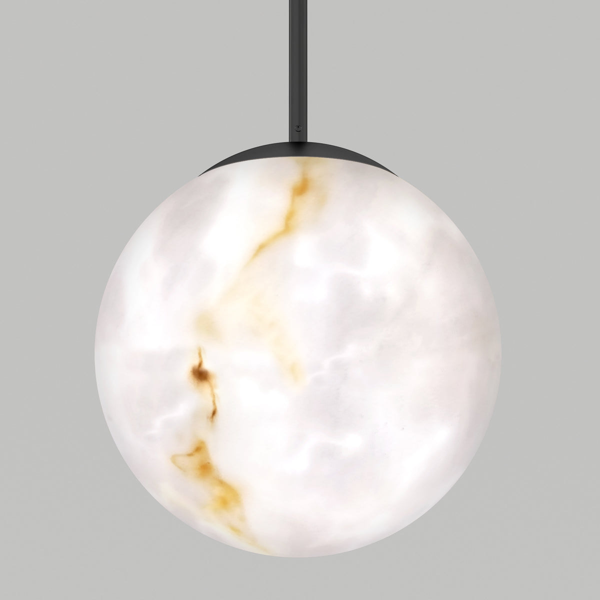 A spherical, marble-like pendant light hangs from a black cord. The shade is white with subtle brown and gold veining, resembling natural stone, set against a plain gray background.