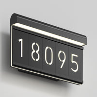 The Artika Bowen modern LED outdoor address wall light 5 CCT displays the number 18095 in black against a light gray wall, featuring white LED backlighting for a sleek, contemporary look.