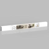 A long, white rectangular box with product labeling and an image showing modern interior furniture, including chairs, a table, and a plant. The packaging is set against a plain gray background.