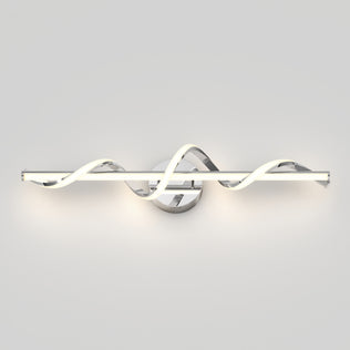 The Artika Coda modern LED bathroom vanity light features a wavy, twisted design and chrome base, emitting a soft white glow against a light gray wall.