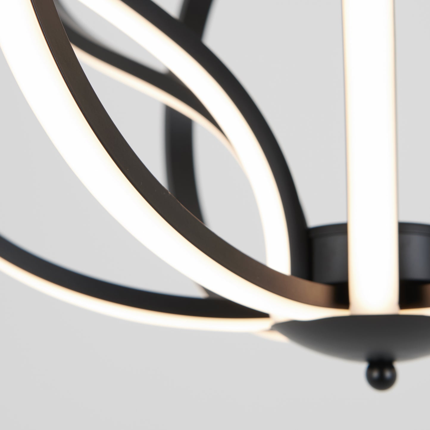 Close-up of the Artika Meridian LED pendant light, featuring curved black metal arms and integrated white LED strips, set against a plain light gray background.