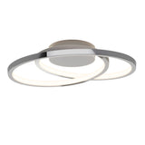A modern ceiling light fixture with two intersecting circular LED rings and a round base, finished in a sleek metallic color.
