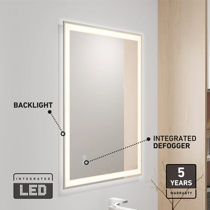 The Artika Sofia LED mirror 3 CCT with defogger is mounted on a light gray wall, featuring an LED backlight and icons for its 5-year warranty. A faucet and part of a wooden cabinet are also visible nearby.