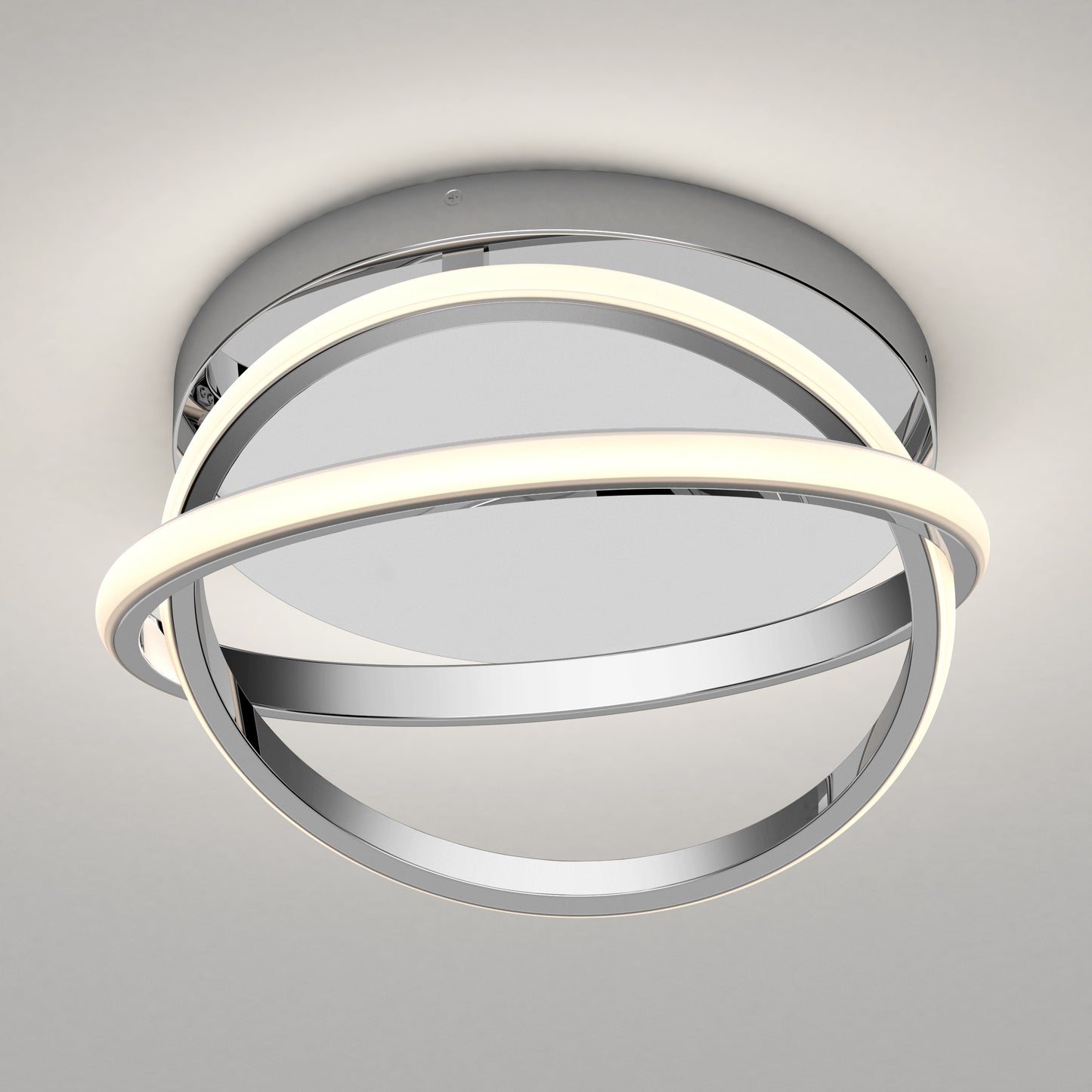 The Artika Orbia modern LED flush mount light 3 CCT features a round chrome base and two intersecting rings, one softly illuminated, for a sleek look on any neutral-colored ceiling.