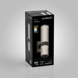 A black box with the brand name Artika displays the Mirado wall light fixture. The box shows an image of the cylindrical, ribbed light, product details, and energy specifications on a gray gradient background.