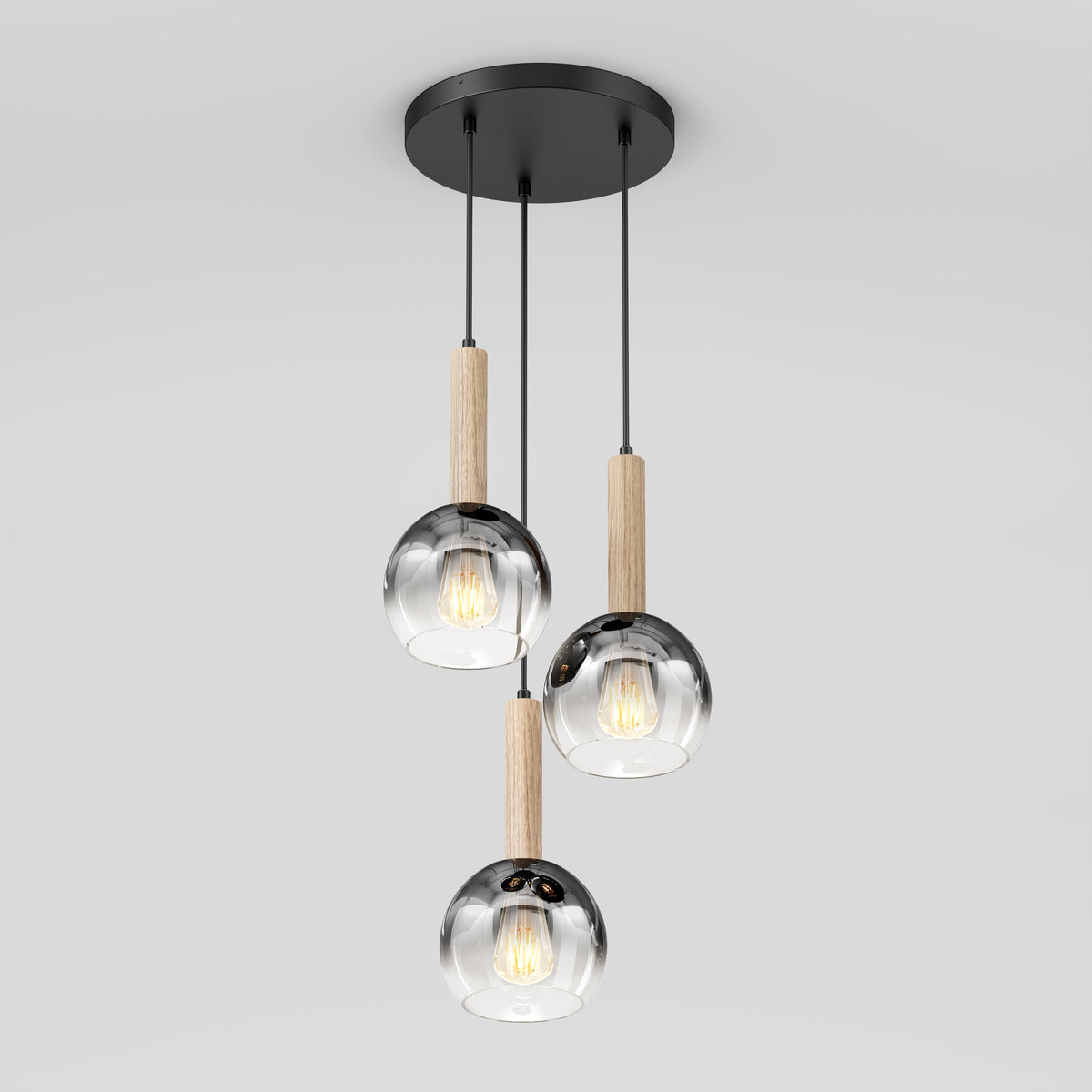 The Artika Ardel Spiral 3-Light Pendant features three glass globes, each hanging from a black mount by black cords with wooden accents above each, and is sold without bulbs.