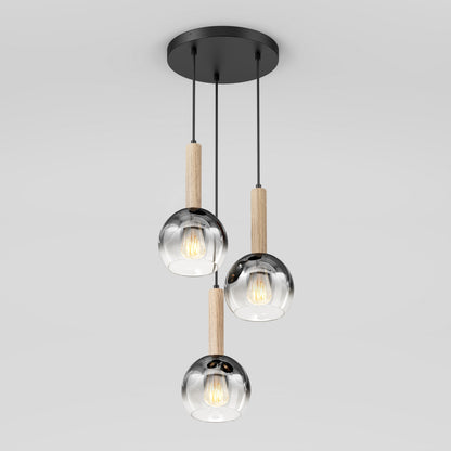 The Artika Ardel Spiral 3-Light Pendant features three glass globes, each hanging from a black mount by black cords with wooden accents above each, and is sold without bulbs.