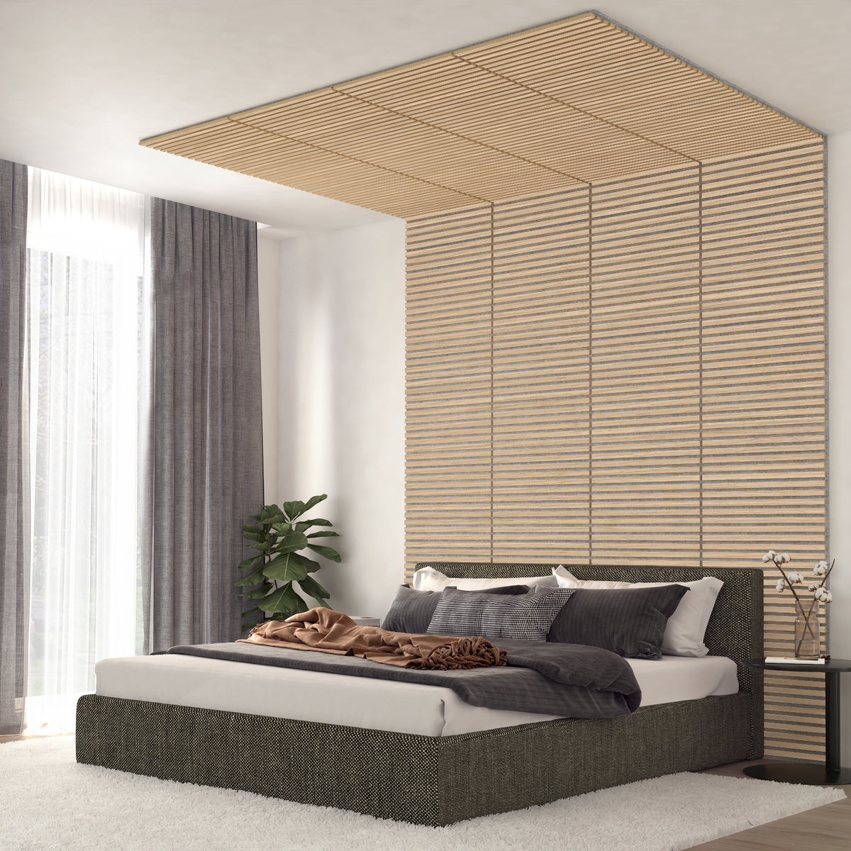 Modern bedroom with a gray bed, textured bedding, and pillows. Wooden slats decorate the wall and ceiling above the bed. Large windows with sheer and gray curtains, a plant, and a soft white rug complete the room.