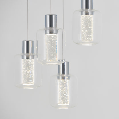 The Artika Champagne Globe 4-light LED pendant features four modern lights with cylindrical, bubble-dotted glass shades and metallic tops, elegantly suspended on thin wires against a plain light gray background.