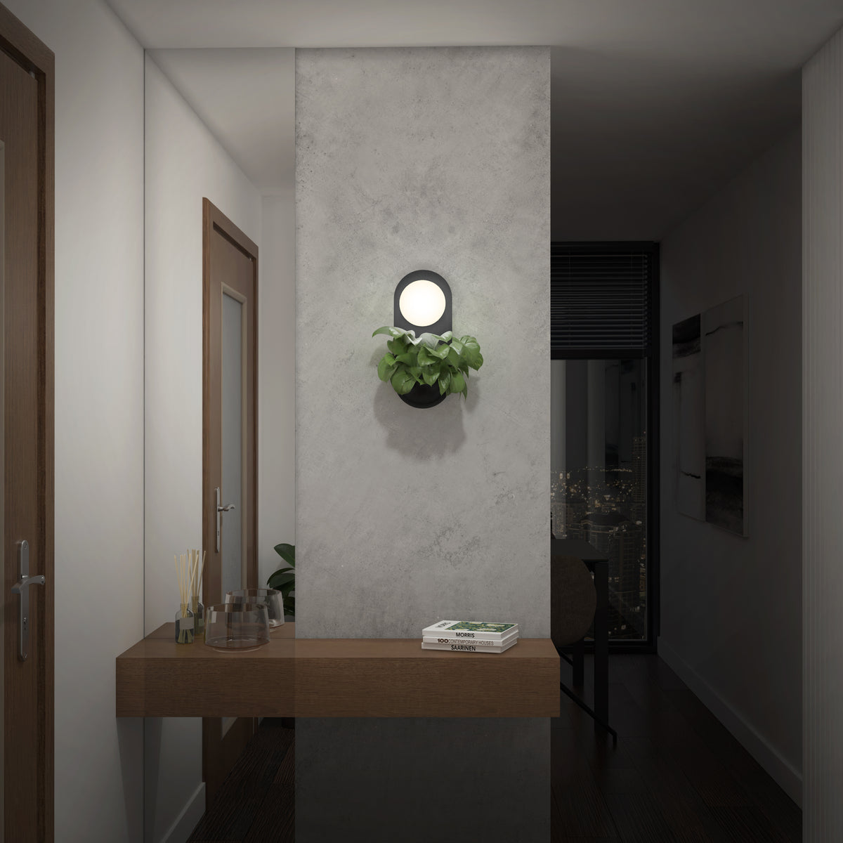 A modern hallway with a floating wooden shelf holding glassware and books, a gray wall with a round light and green plant, and a view into a dark room with city lights outside the window.
