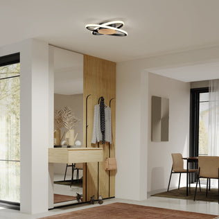 Modern entryway with wood accent wall, mirror, coat hooks, and Artika Atomic 15 in. LED flush mount 5 CCT; dining area beyond.