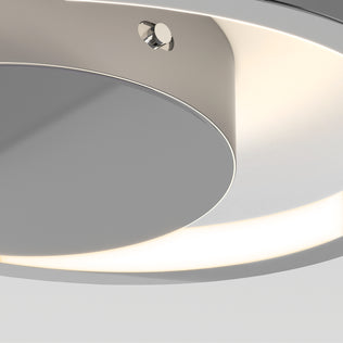 Close-up of the Artika Salto LED flush mount light, a modern circular ceiling fixture with a sleek metallic finish, emitting soft white light.