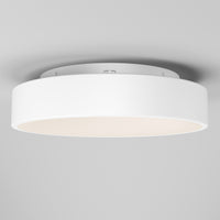 The Artika Aiden LED flush mount is a modern, round white ceiling light with a smooth, minimalist design. Mounted on a light-colored ceiling, it emits a soft, even glow.