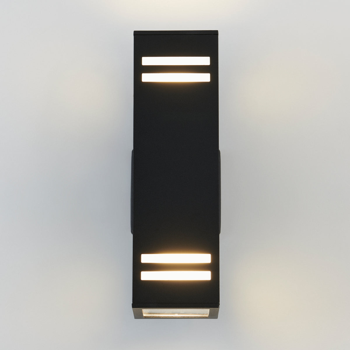 A modern black wall sconce with rectangular design, featuring two horizontal LED light strips at the top and bottom, mounted on a light-colored wall.