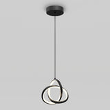 A modern pendant light with three intersecting black rings, each containing an LED strip, hangs from a round black ceiling mount against a plain gray background.