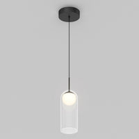 The Artika Mirah LED modern mid-century pendant light 3 CCT features a black ceiling mount and cord with a clear cylindrical glass shade around a glowing bulb, set against a plain light gray background.