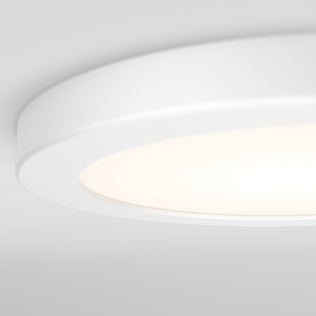 Close-up of the Artika Europa Disk 7 in. LED modern flush mount light glowing softly on a light gray ceiling, featuring 3 CCT dimmable white technology for customizable ambiance.