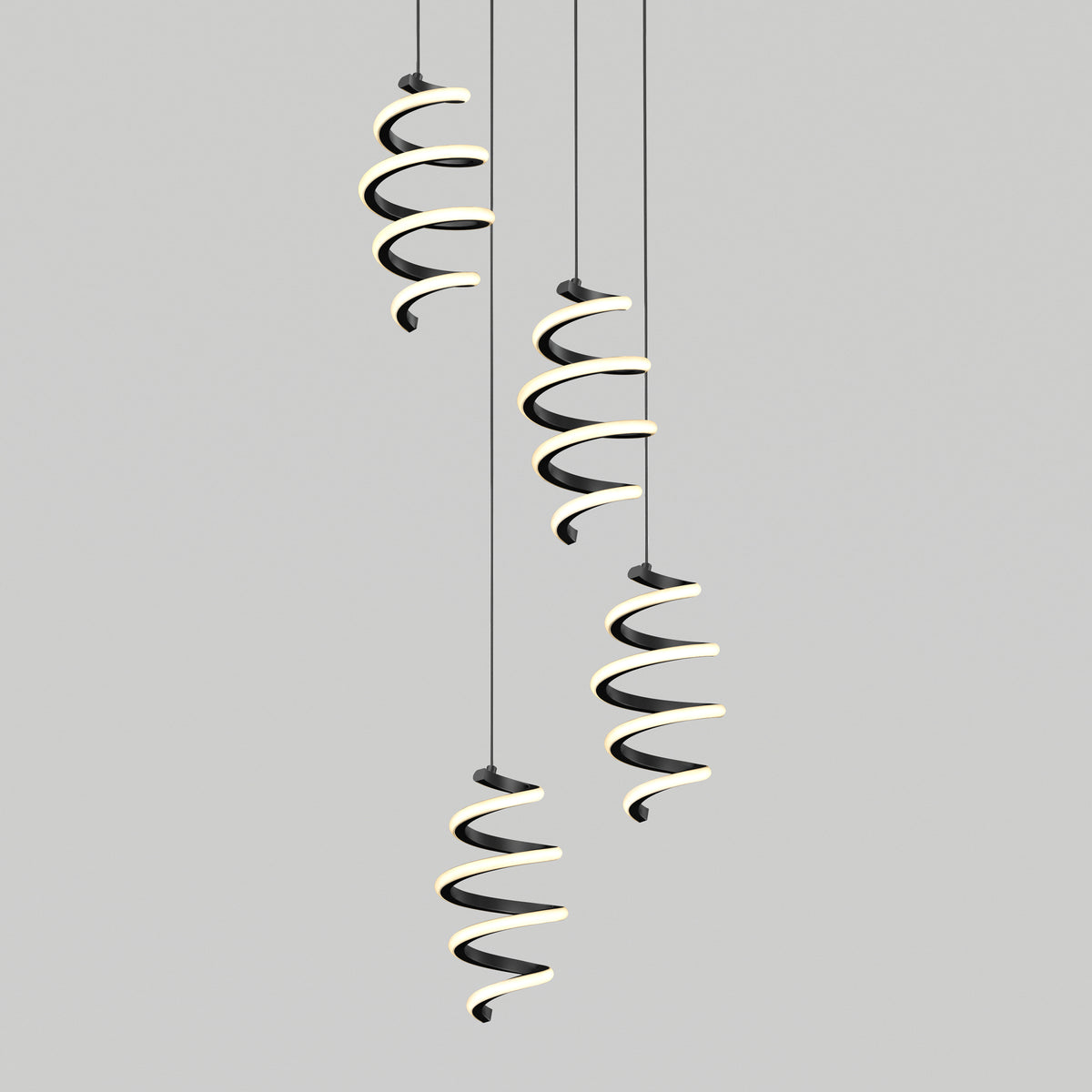 Four modern Chorus LED pendant lights by Artika, featuring spiral black and white designs, hang at varying heights against a plain gray background.